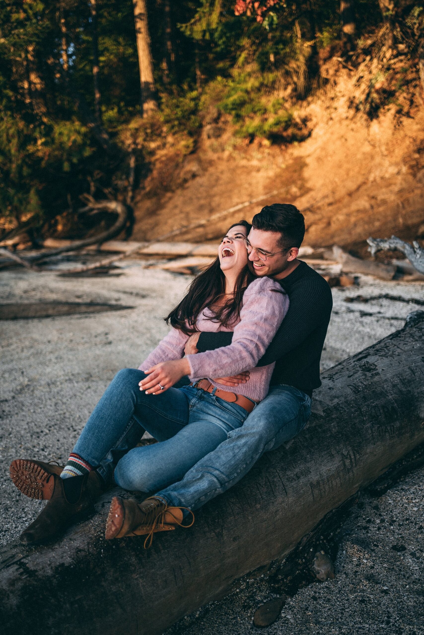 couple laughing at engagement photoshoot on galiano island