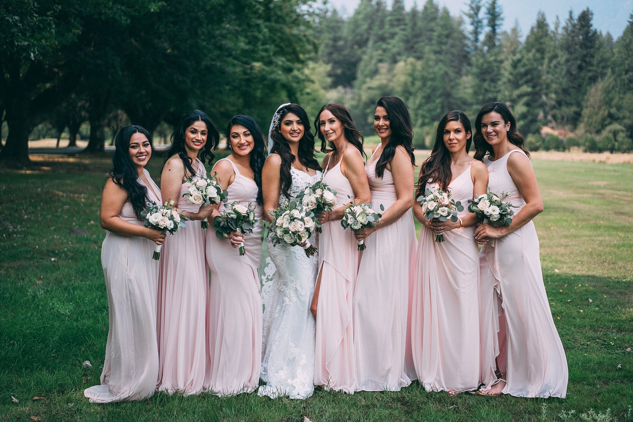 bridesmaids in pink dresses with bride in middle