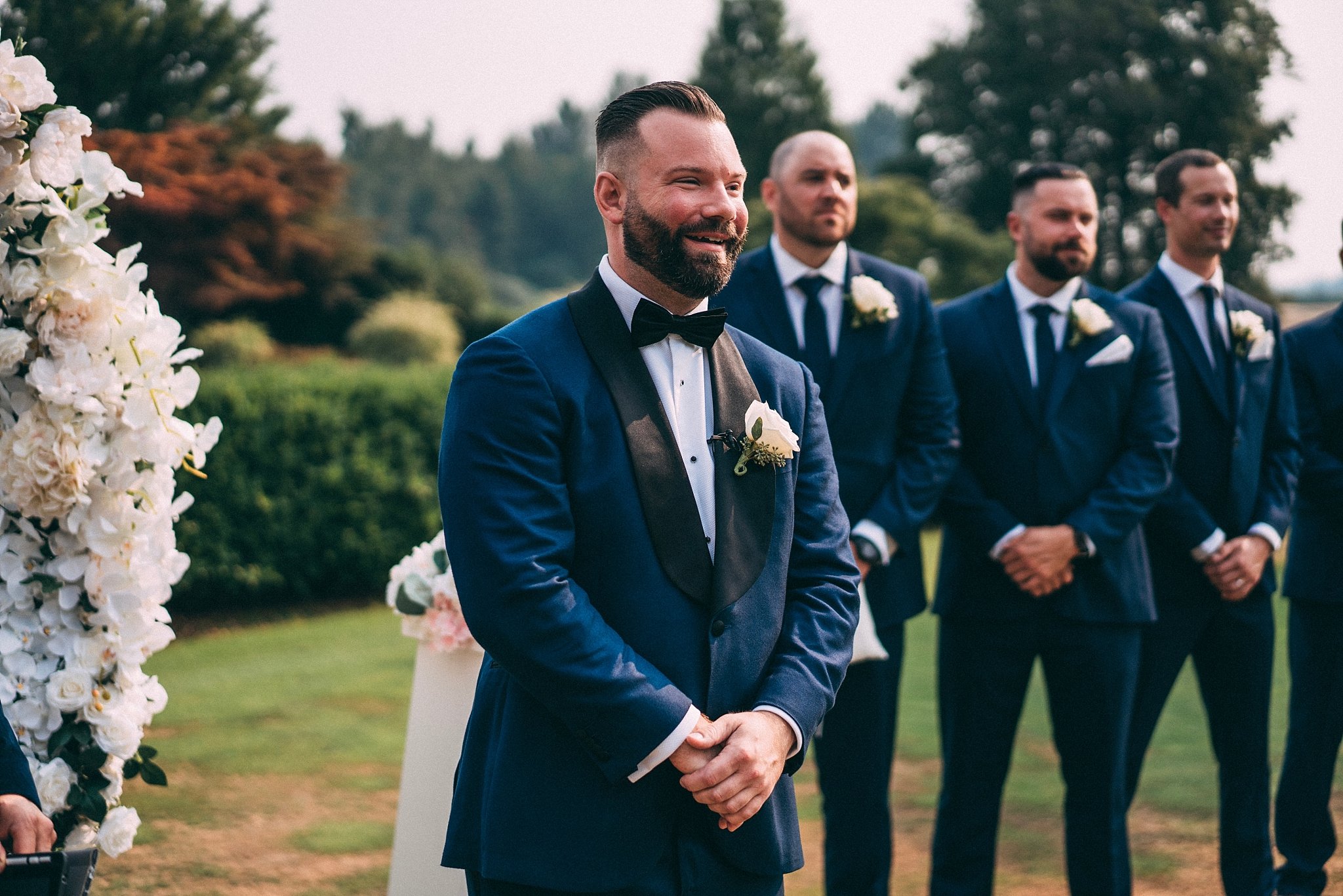 groom smiling at wedding ceremony
