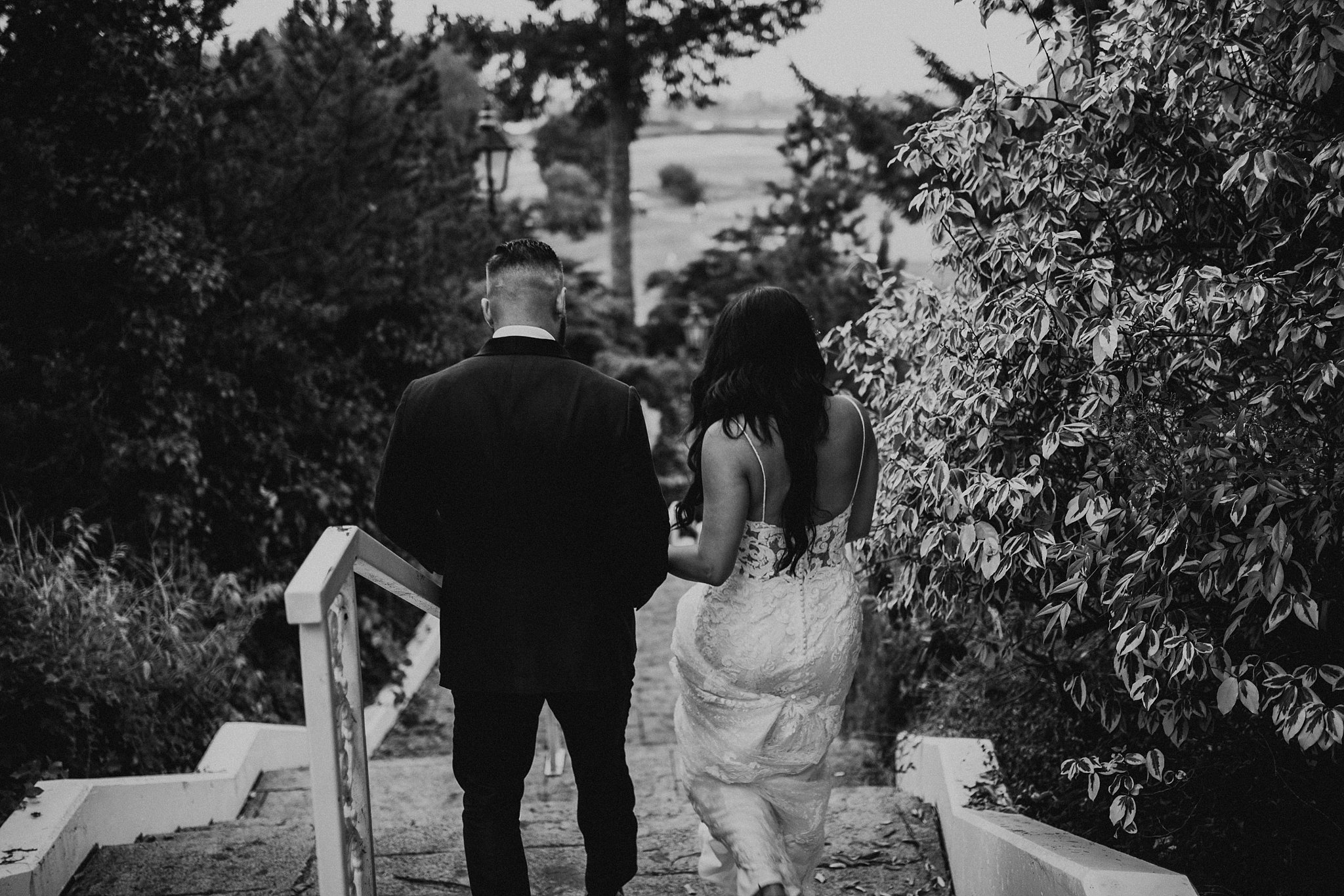 couple walking down stairs on wedding day