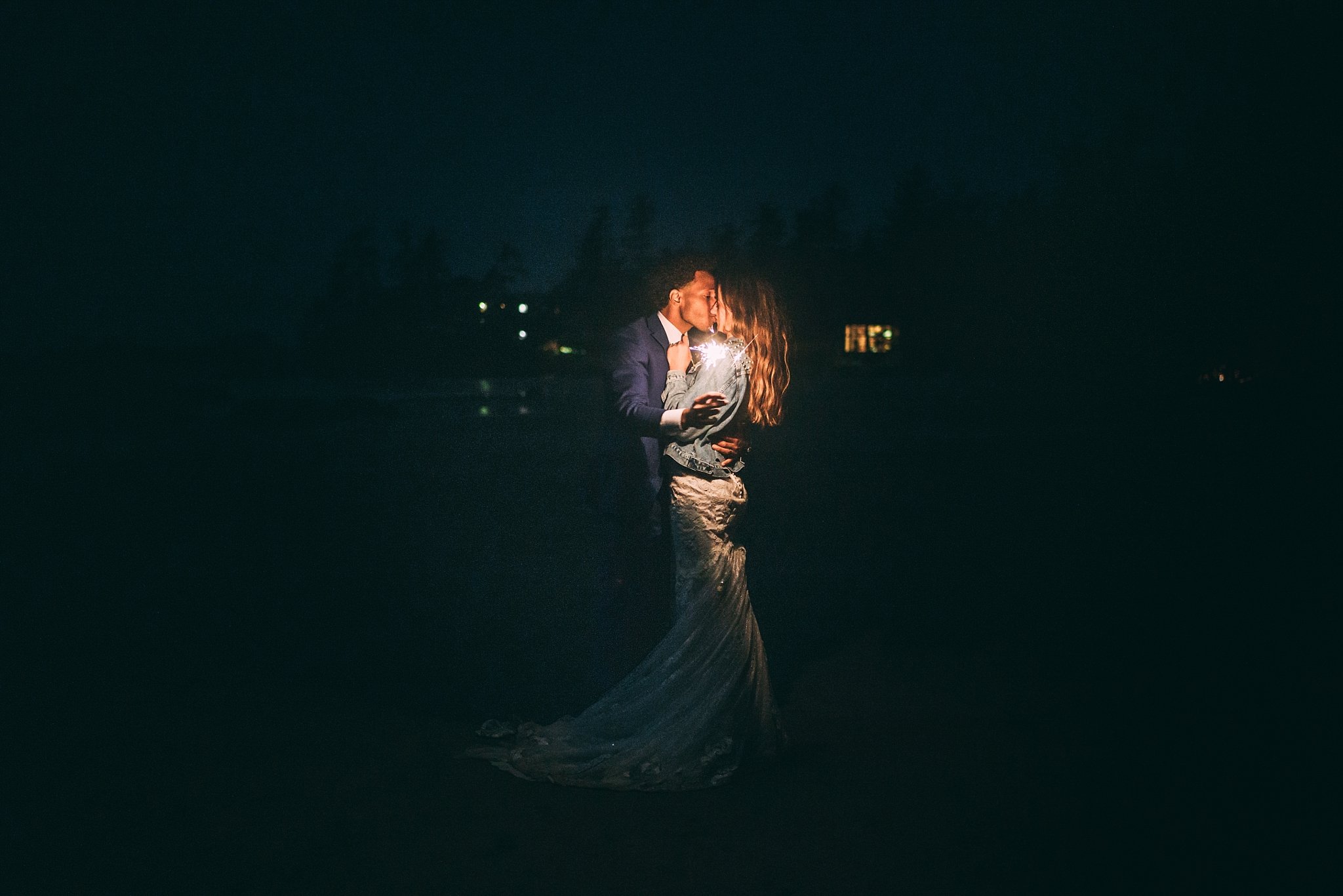 bride and groom at night kissing