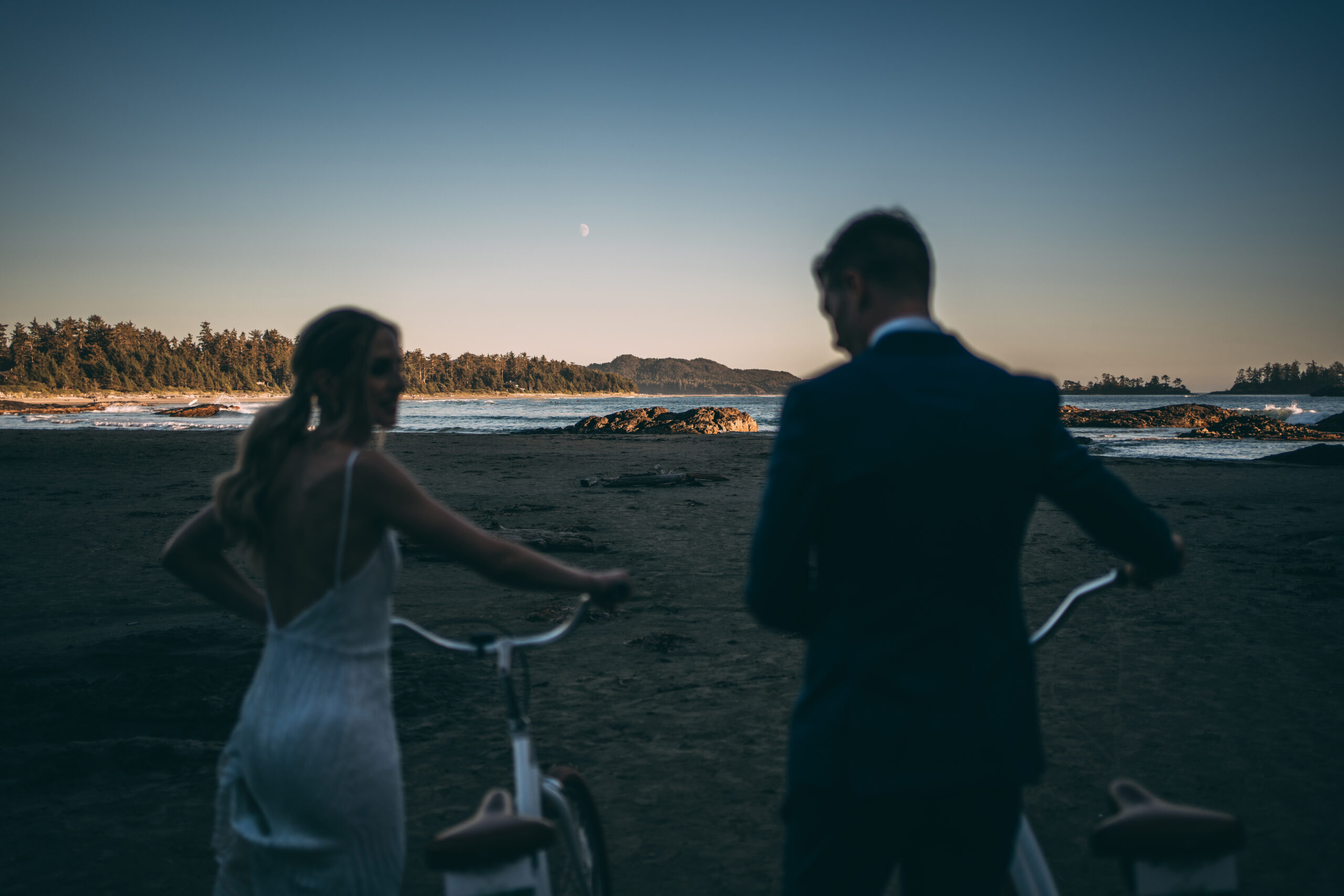 elopement couple with bikes on chesterman beach, tofino